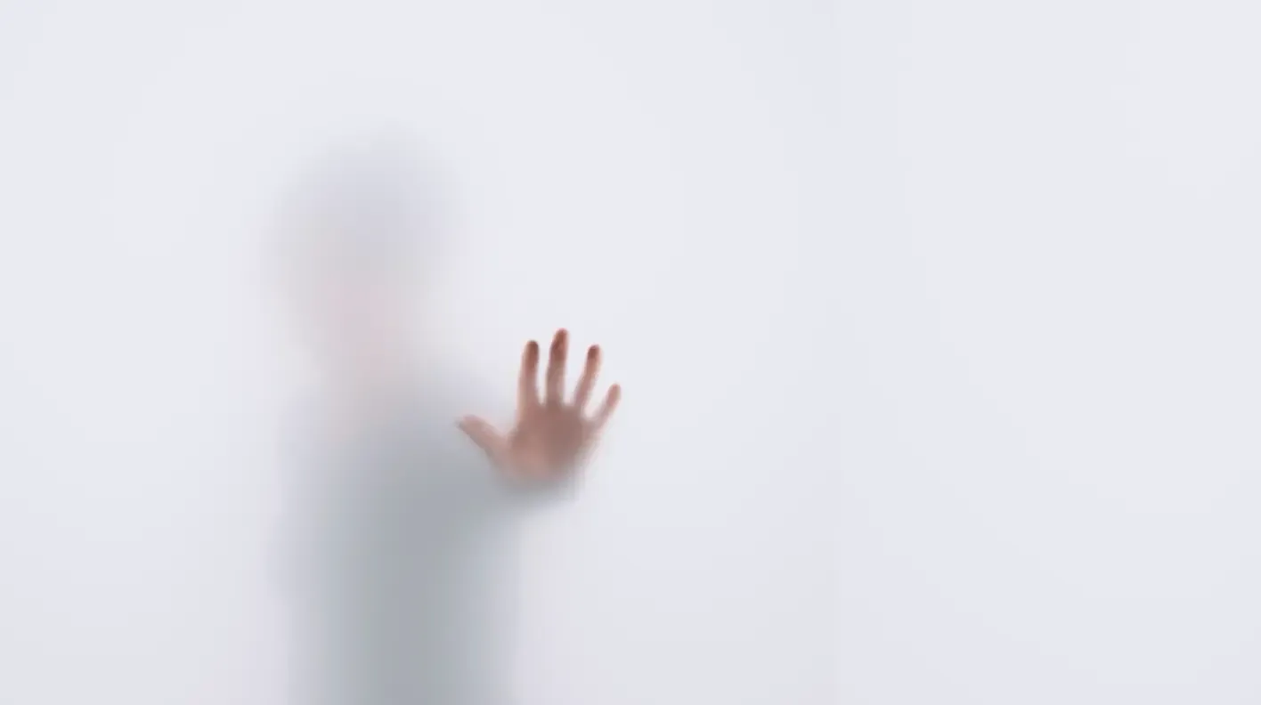 Blurry image with hand on window