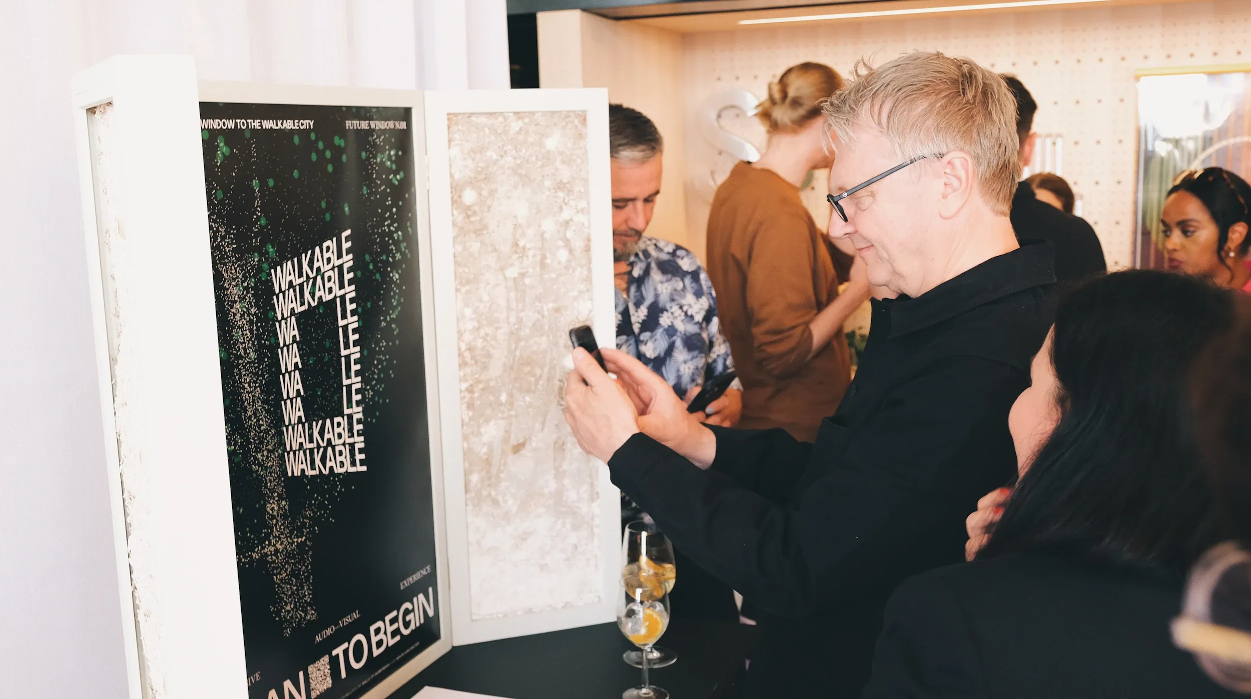 People scanning a QR code for the Future Window app