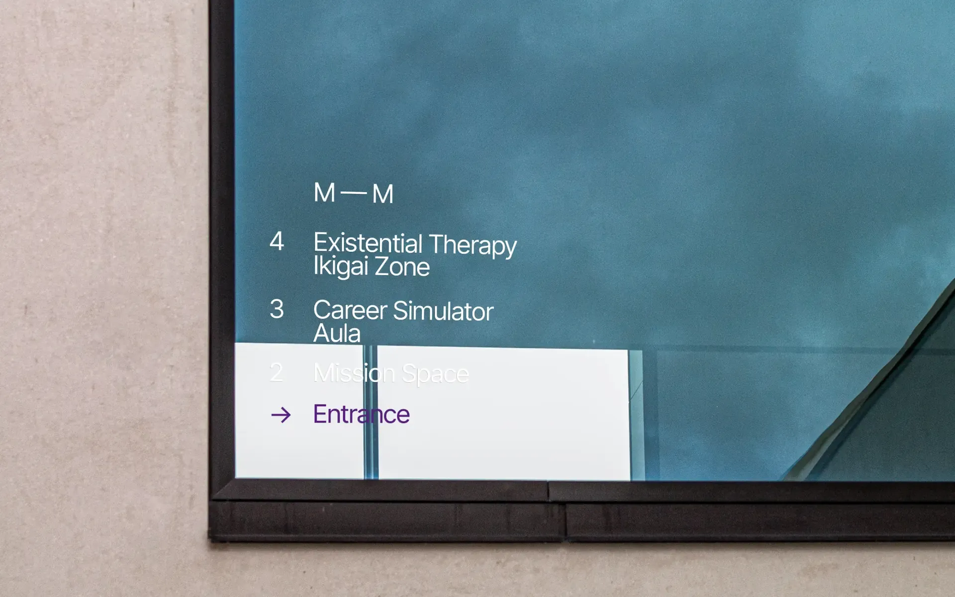 Modern directional sign on glass showing floor listings for “Existential Therapy,” “Ikigai Zone,” “Career Simulator,” and “Mission Space,” with a purple arrow pointing to the entrance.