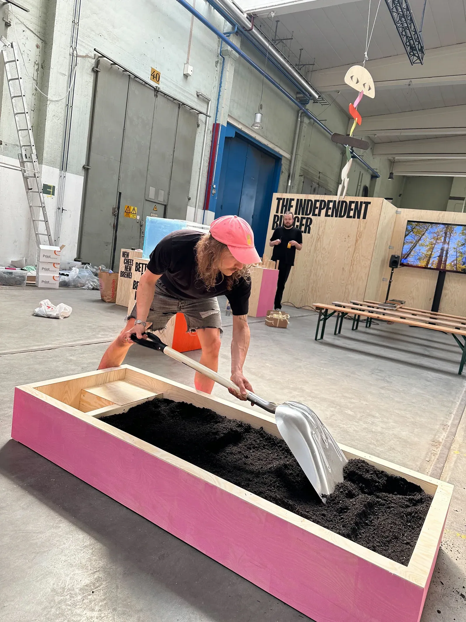 Incredibly handsome man digging in soil for the The Independent Food City  exhibition